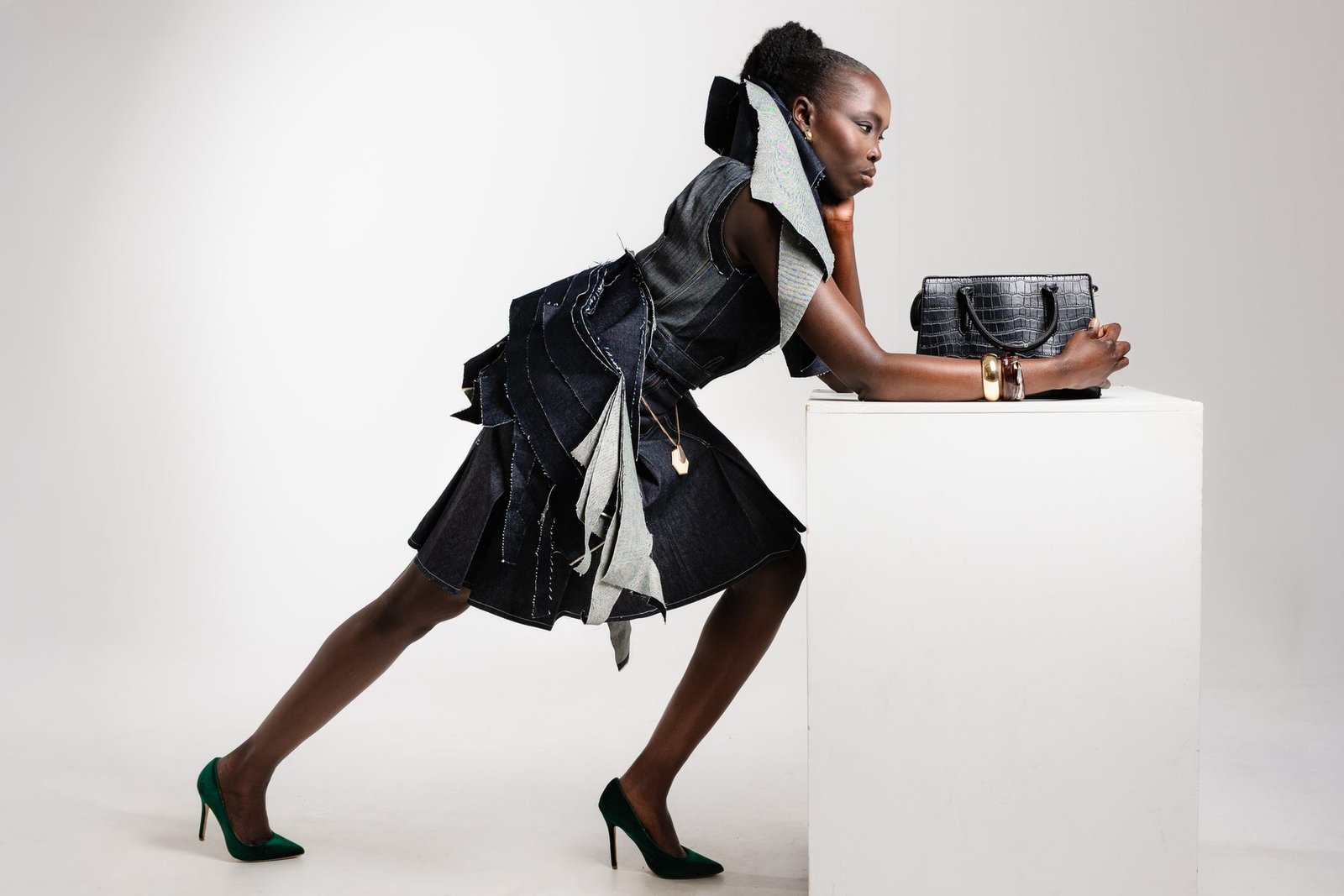 Horizontal studio image of sculptural denim look
